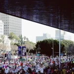 crowd of people near concrete buildings during daytime